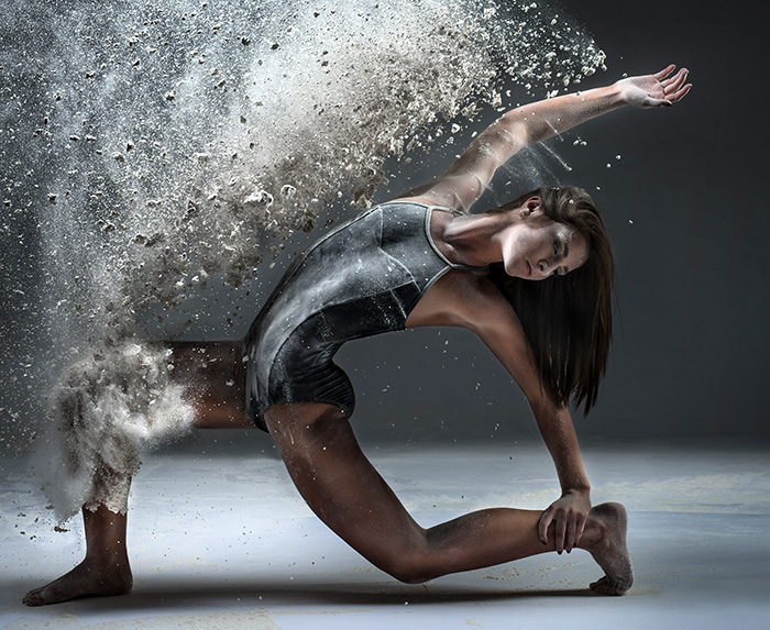 dayton dance conservatory dancer action pose throwing flour