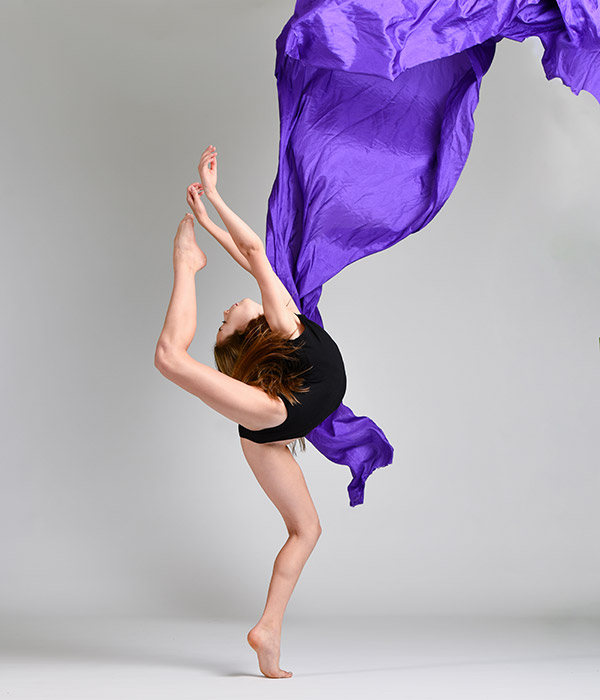 dayton dance conversatory dancer in blue leotard sitting on orange metal stair frame