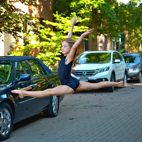 dayton dance conservatory dancer jumping pose in street downtown ohio